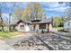 Charming one-story home with white siding, orange trim, and a welcoming front porch at 908 W Airline Ave, Gastonia, NC 28052