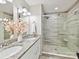 Modern bathroom featuring double sinks with granite countertop and glass-enclosed shower with tiled walls at 9723 Mattforest Cir, Charlotte, NC 28277