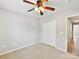 Inviting bedroom with ceiling fan, closet space, and built-in shelves for extra storage at 9723 Mattforest Cir, Charlotte, NC 28277