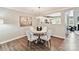 Cozy dining area with a modern chandelier, hardwood floors, and view into the kitchen at 9723 Mattforest Cir, Charlotte, NC 28277