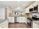 Kitchen with stainless steel appliances, white cabinets, and granite countertops at 9723 Mattforest Cir, Charlotte, NC 28277