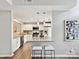 Modern kitchen with stainless steel appliances, granite countertops, and stylish bar seating at 9723 Mattforest Cir, Charlotte, NC 28277