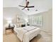 Cozy bedroom with a ceiling fan, two side tables, and a bright window at 9723 Mattforest Cir, Charlotte, NC 28277