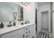 Elegant bathroom with double sinks, white cabinets, and a walk-in closet, featuring modern fixtures at 1024 Scotch Meadows Loop # 32, Monroe, NC 28110