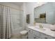Well-lit bathroom featuring a bathtub with shower, vanity with sink, and decorative mirror at 1024 Scotch Meadows Loop # 32, Monroe, NC 28110