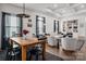 Open-concept dining area with a wooden table and stylish chairs, seamlessly connected to a cozy living space at 1024 Scotch Meadows Loop # 32, Monroe, NC 28110