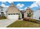 Charming brick home with a well-manicured lawn and a two-car garage with an inviting entrance and beautiful landscaping at 1024 Scotch Meadows Loop # 32, Monroe, NC 28110