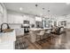 Modern open kitchen with a white island, stainless steel appliances, dark wood floors, and breakfast bar seating at 1024 Scotch Meadows Loop # 32, Monroe, NC 28110