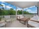 Inviting screened porch with comfortable seating and scenic views of lush greenery and blue sky at 1024 Scotch Meadows Loop # 32, Monroe, NC 28110