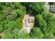 Aerial view of a home nestled in a lush, green, wooded area, offering privacy at 122 Roxboro Ct # 286, Mount Gilead, NC 27306