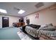 Finished basement area with carpet, futon bed, and TV with shelving unit at 122 Roxboro Ct # 286, Mount Gilead, NC 27306