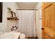 Compact bathroom with vanity, toilet, and a stylish, striped shower curtain at 122 Roxboro Ct # 286, Mount Gilead, NC 27306