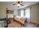 Well-lit bedroom featuring wood-look flooring, natural light, and comfortable bed at 122 Roxboro Ct # 286, Mount Gilead, NC 27306