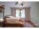 Cozy bedroom featuring wood-look floors and a comfortable bed with a view of the outdoors at 122 Roxboro Ct # 286, Mount Gilead, NC 27306