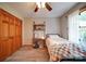 Bedroom with wood floors, closet, and shelves at 122 Roxboro Ct # 286, Mount Gilead, NC 27306