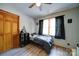 Well-lit bedroom featuring wood-look flooring, natural light, and a closet at 122 Roxboro Ct # 286, Mount Gilead, NC 27306