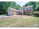 Inviting home featuring a well-manicured lawn, covered porch, and attached two car garage at 122 Roxboro Ct # 286, Mount Gilead, NC 27306