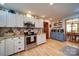 Well-lit kitchen showcases white cabinets, stainless steel appliances, and wood flooring at 122 Roxboro Ct # 286, Mount Gilead, NC 27306