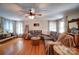 Cozy living room boasts hardwood floors, a ceiling fan, and ample natural light at 122 Roxboro Ct # 286, Mount Gilead, NC 27306