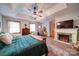Spacious main bedroom featuring a fireplace, tray ceiling, and wood flooring at 122 Roxboro Ct # 286, Mount Gilead, NC 27306