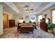 Spacious main bedroom with a tray ceiling, ceiling fan, and wood flooring at 122 Roxboro Ct # 286, Mount Gilead, NC 27306