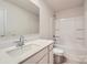 Well-lit bathroom featuring a single sink vanity and a shower-tub combination at 134 Dorian Pl, Troutman, NC 28166