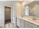 Bathroom featuring double sinks, modern fixtures, and a walk-in closet at 134 Dorian Pl, Troutman, NC 28166