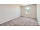 Comfortable bedroom featuring a large window with natural light and carpeted floors at 134 Dorian Pl, Troutman, NC 28166