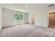 Neutral bedroom featuring a large window with natural light and carpeted floors at 134 Dorian Pl, Troutman, NC 28166