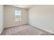 Cozy bedroom featuring a large window with natural light and carpeted floors at 134 Dorian Pl, Troutman, NC 28166