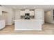 Stylish kitchen with white cabinetry, a central island, modern appliances, and hardwood floors at 134 Dorian Pl, Troutman, NC 28166