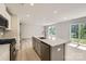 Modern kitchen featuring a central island, stainless steel appliances, and hardwood floors at 134 Dorian Pl, Troutman, NC 28166