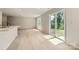 Spacious living room with hardwood floors and sliding glass doors that provide access to the backyard at 134 Dorian Pl, Troutman, NC 28166