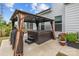 Backyard featuring a patio with a hot tub under a gazebo, grill, flower pots, and lush plants at 1548 Striped Bass Ln, Clover, SC 29710