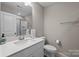 Bright bathroom featuring a glass enclosed shower, white vanity with sink, and modern fixtures at 1548 Striped Bass Ln, Clover, SC 29710
