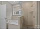 Bathroom featuring a separate shower and bathtub with natural light from a large window at 1548 Striped Bass Ln, Clover, SC 29710
