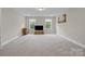Large, carpeted bonus room with windows, offering ample natural light at 1548 Striped Bass Ln, Clover, SC 29710