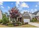 Charming two-story home with a brick and gray facade, manicured lawn, and a two-car garage at 1548 Striped Bass Ln, Clover, SC 29710