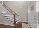 Bright foyer with hardwood floors, staircase, and natural light streaming through the entry door at 1548 Striped Bass Ln, Clover, SC 29710