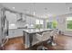 Modern kitchen with a large center island, pendant lights, and stainless steel appliances at 1548 Striped Bass Ln, Clover, SC 29710