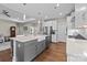 Bright kitchen with stainless steel appliances, white cabinets, and large island with a farm sink at 1548 Striped Bass Ln, Clover, SC 29710
