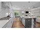 Modern kitchen features white cabinets, stainless steel appliances, and a center island with bar seating at 1548 Striped Bass Ln, Clover, SC 29710