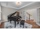 Elegant living room featuring a grand piano, tray ceiling, and doorway at 1548 Striped Bass Ln, Clover, SC 29710