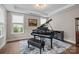 Elegant living room featuring a grand piano, tray ceiling, and plenty of natural light at 1548 Striped Bass Ln, Clover, SC 29710