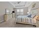 Comfortable main bedroom featuring tray ceiling, carpet and natural light from large windows at 1548 Striped Bass Ln, Clover, SC 29710