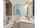 Bathroom featuring double sinks with marble countertops and a shower/tub combo at 2246 Sharon Rd, Charlotte, NC 28207