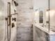 A marble shower with bronze hardware complements this bathroom with glass shower door at 2246 Sharon Rd, Charlotte, NC 28207