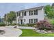 Beautiful white brick home with mature landscaping and a curving walkway leading to the front door at 2246 Sharon Rd, Charlotte, NC 28207