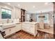 Stylish kitchen with white cabinets, marble countertops, and hardwood floors at 2246 Sharon Rd, Charlotte, NC 28207