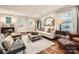 Cozy living room featuring a comfortable sofa, ottoman, and hardwood floors at 2246 Sharon Rd, Charlotte, NC 28207